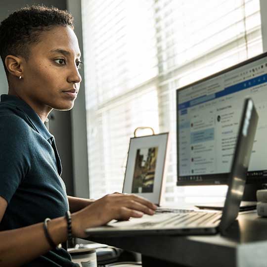 Young woman working on desktop computer in office