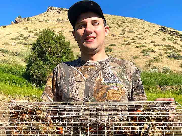 Jake Burrell holding a Crayster crawfish trap