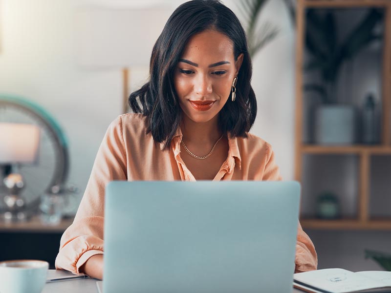 Young Lady With Soft Smile Looking At Computer