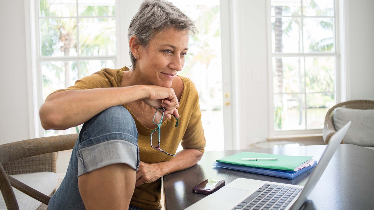 Woman using laptop in living room